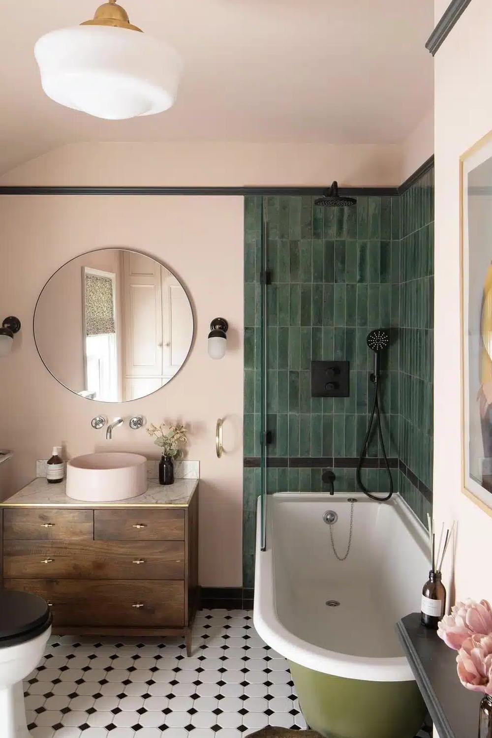 A Victorian-style bathroom with blush pink walls and a modern bathtub.