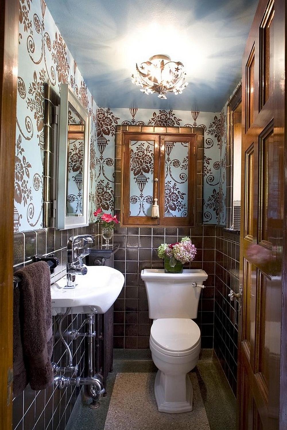 An elegant Victorian bathroom characterized by floral wallpaper and classic fixtures.