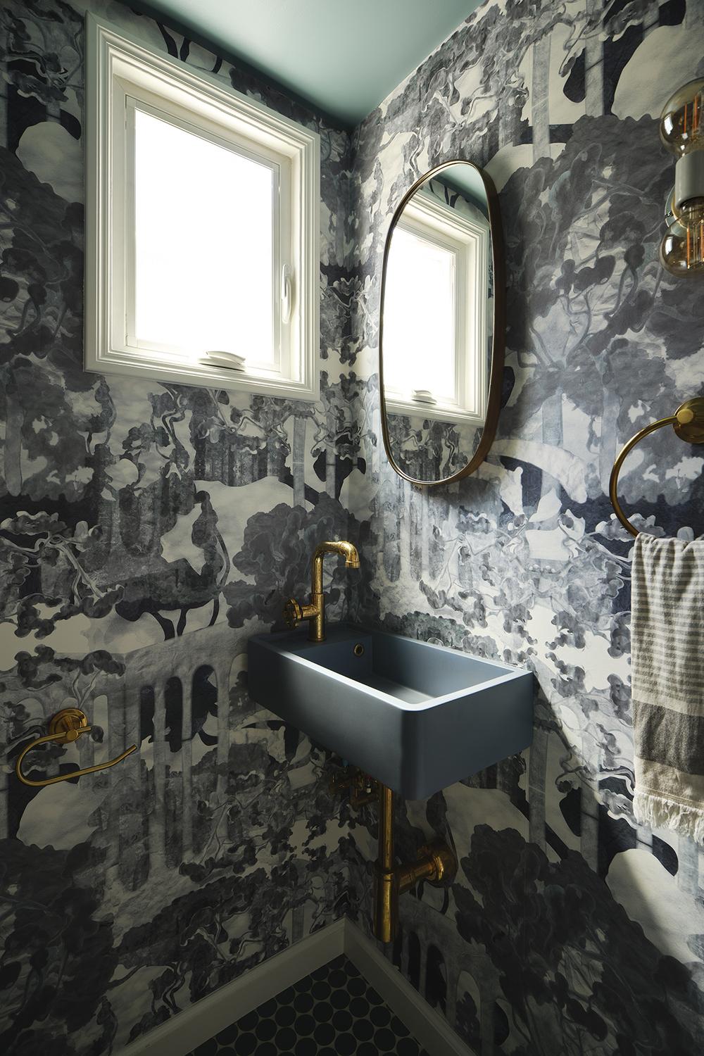 A striking vintage maximalist bathroom with intricate wallpaper and elegant fixtures