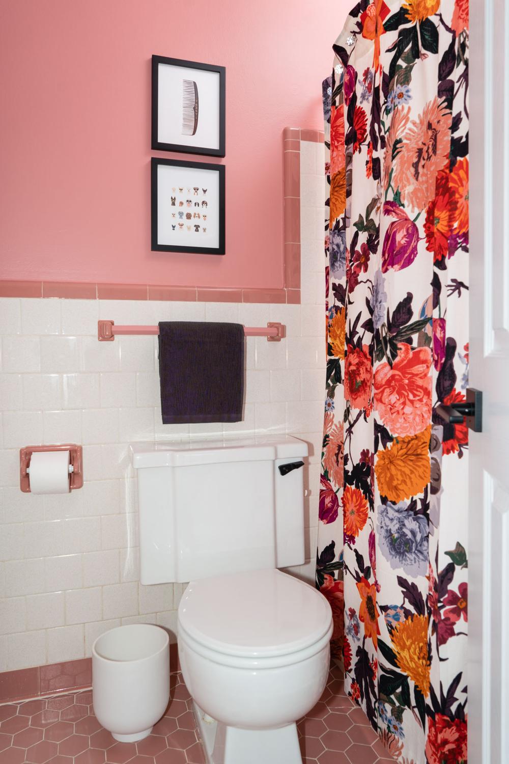 Eclectic vintage bathroom featuring warm pink walls and fun patterned elements.