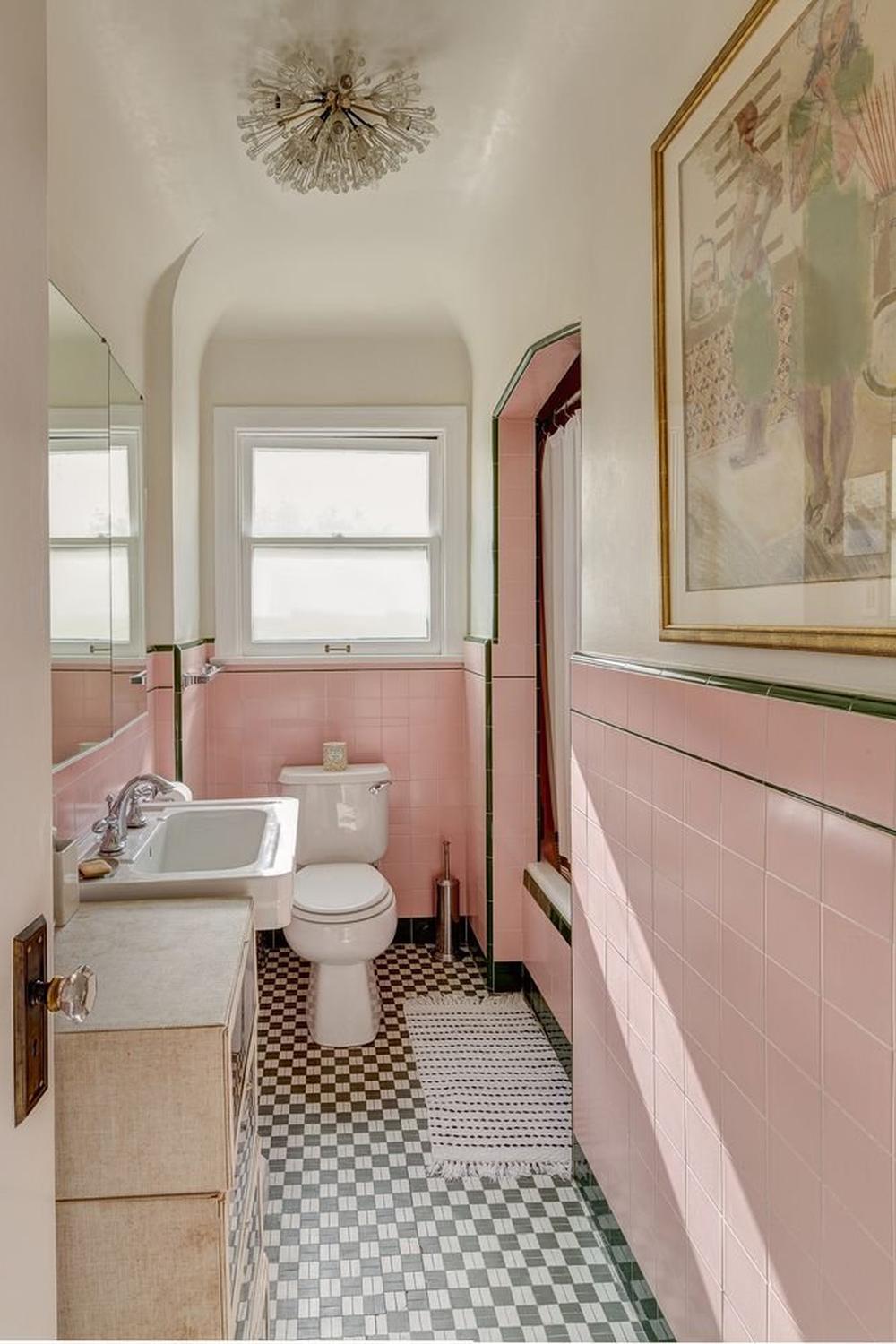 Mid-century vintage pink tile bathroom with charming accents.