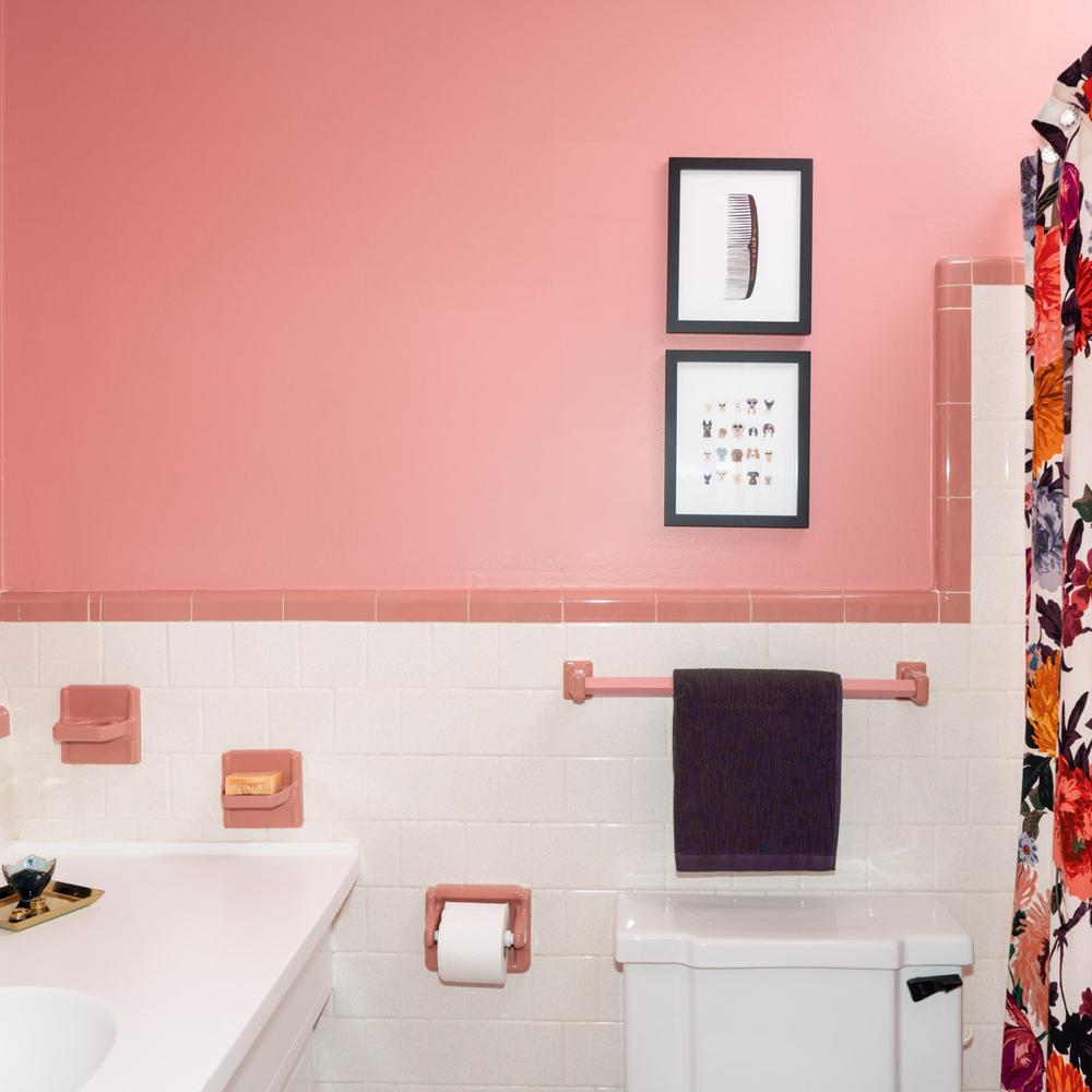 Timeless vintage pink tile bathroom with decorative accents and modern elements.