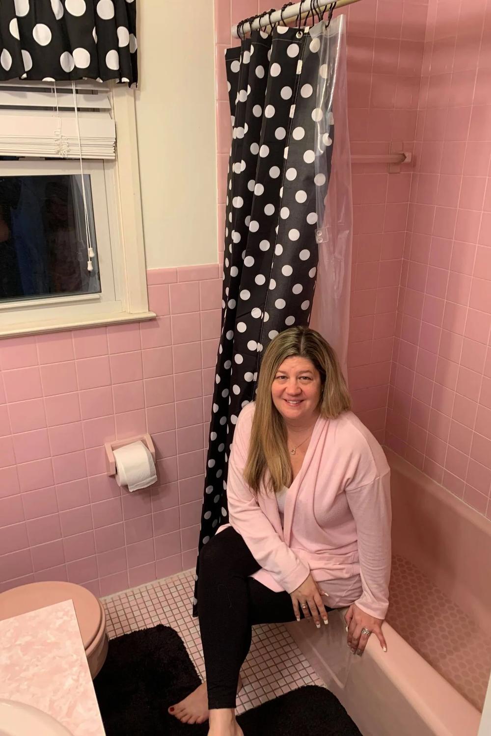 Vintage pink bathroom with a stylish black and white contrast.
