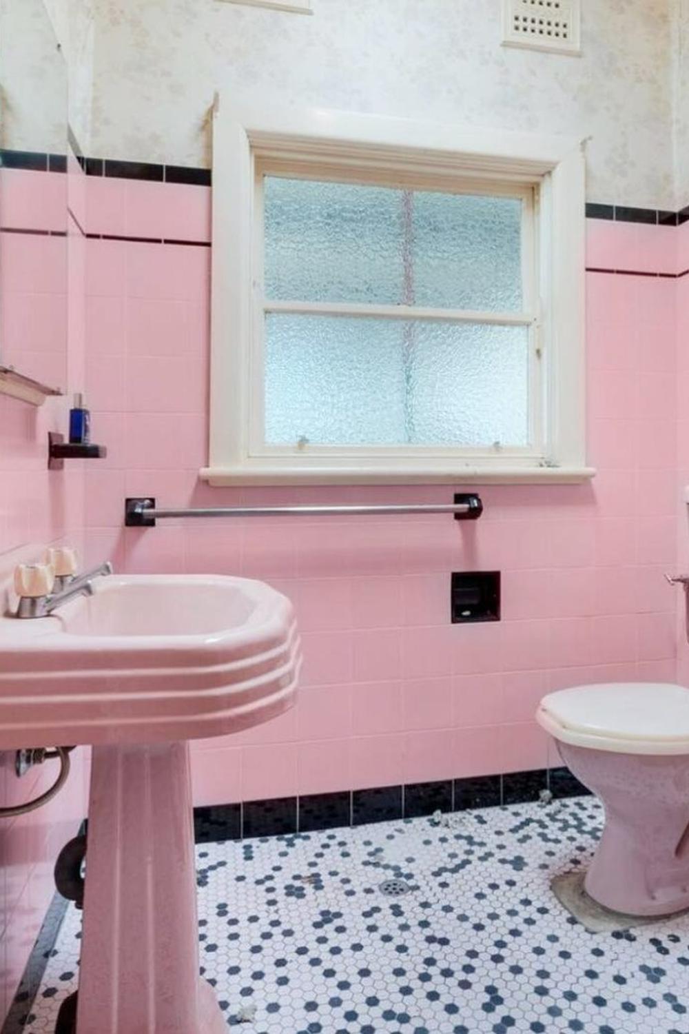 Vintage-style pink tile bathroom reflecting mid-20th century charm.