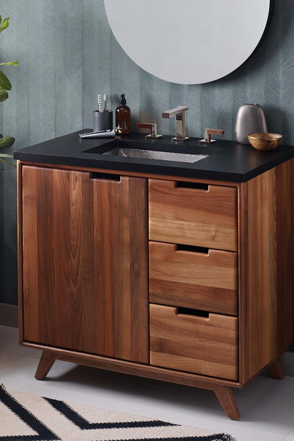 Stylish walnut bathroom vanity with a modern design featuring a dark black surface and elegant fixtures.