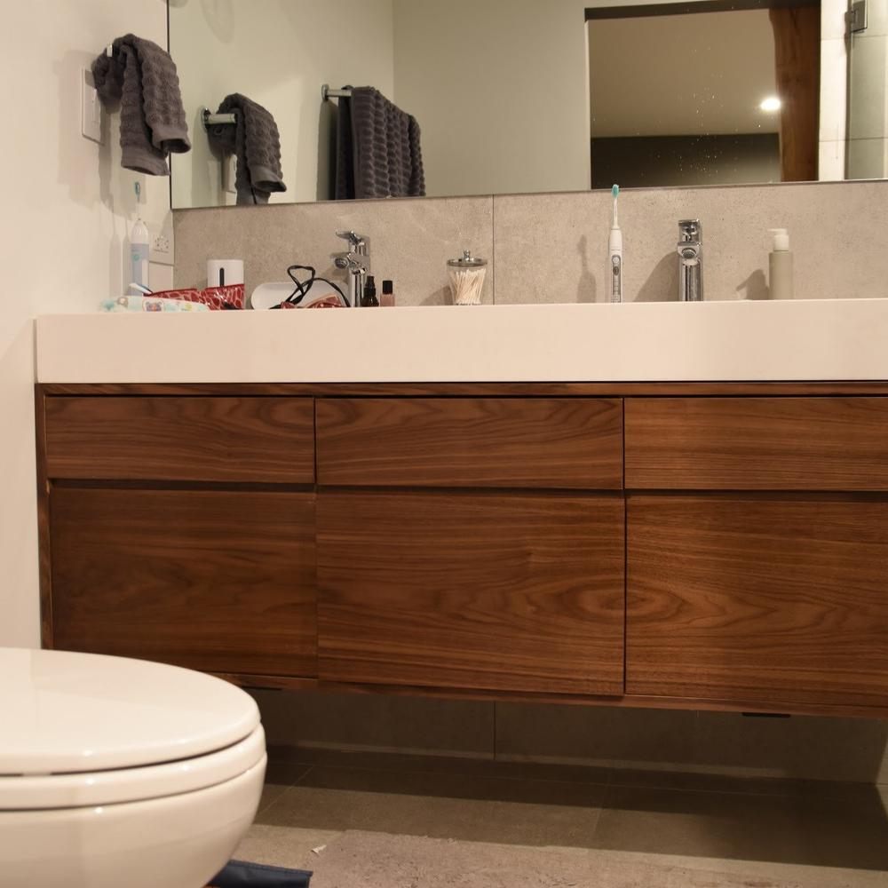 Striking contemporary walnut vanity embracing dual sink feature.