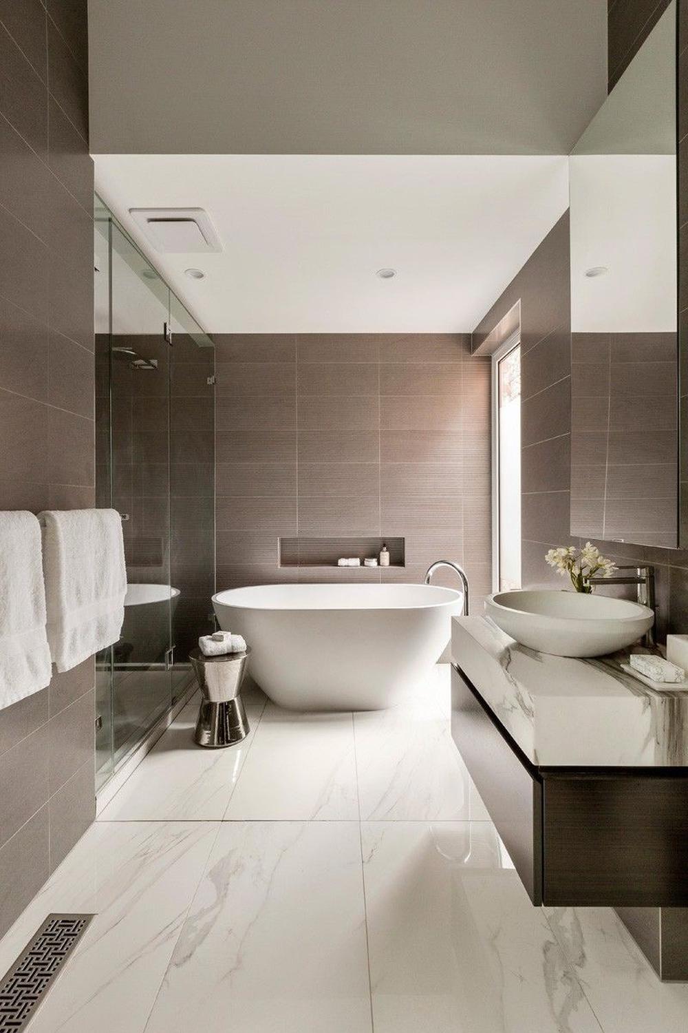 A luxurious minimalistic bathroom with an oval freestanding bathtub.