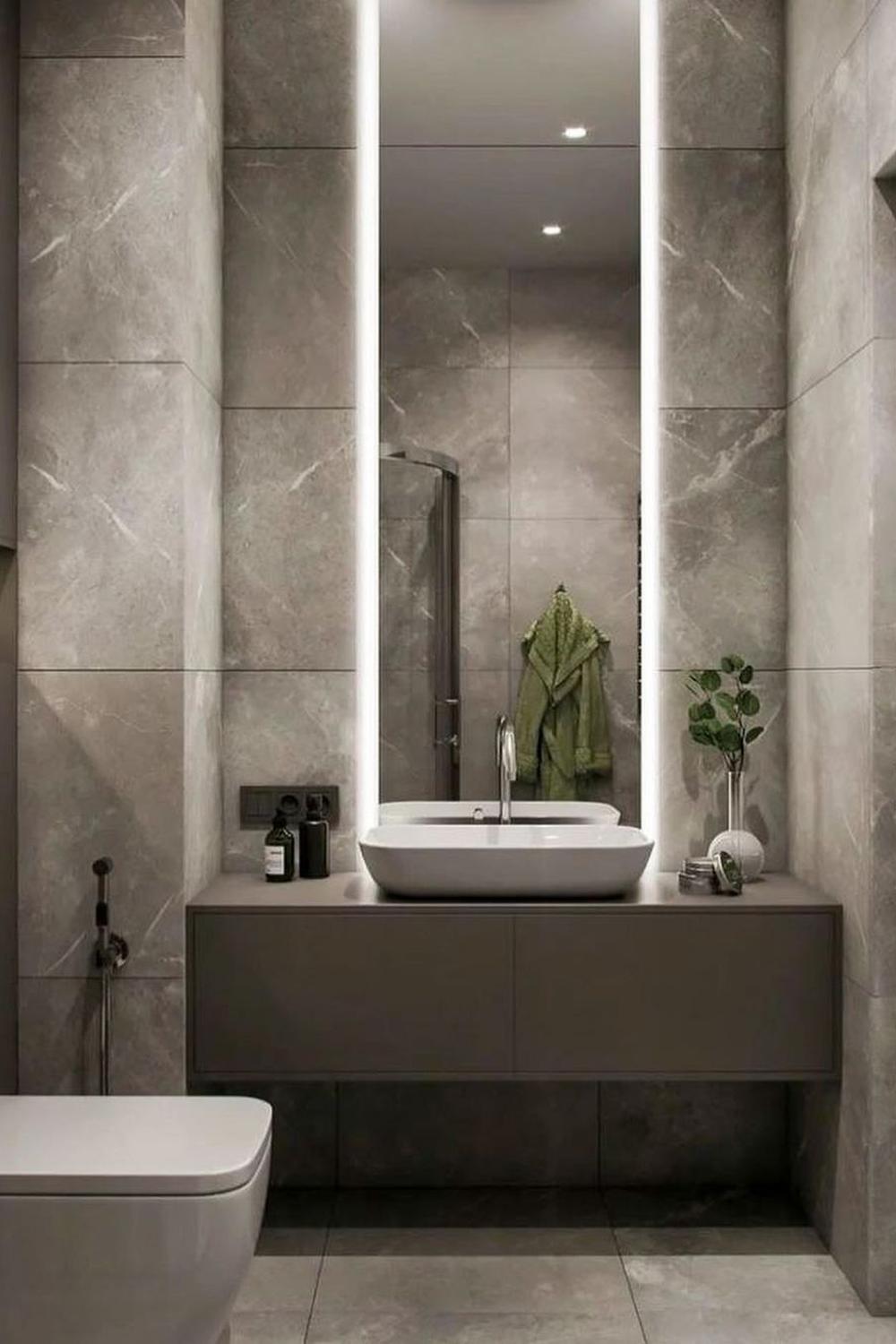 A modern minimalistic bathroom featuring organic elements and a balance of neutral tones.