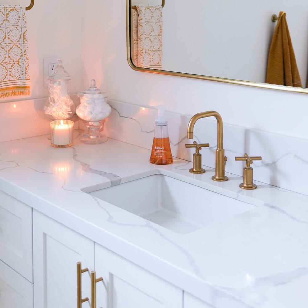 Luxury meets minimalism in a modern sink area with gold fixtures.