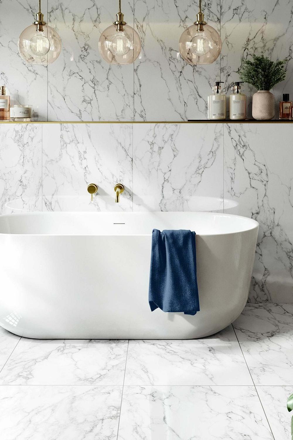 Luxurious bathroom featuring a freestanding bathtub and elegant gold fixtures.