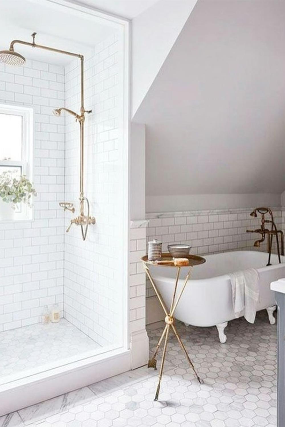 Harmonious bathroom design in white and gold with a freestanding bathtub.