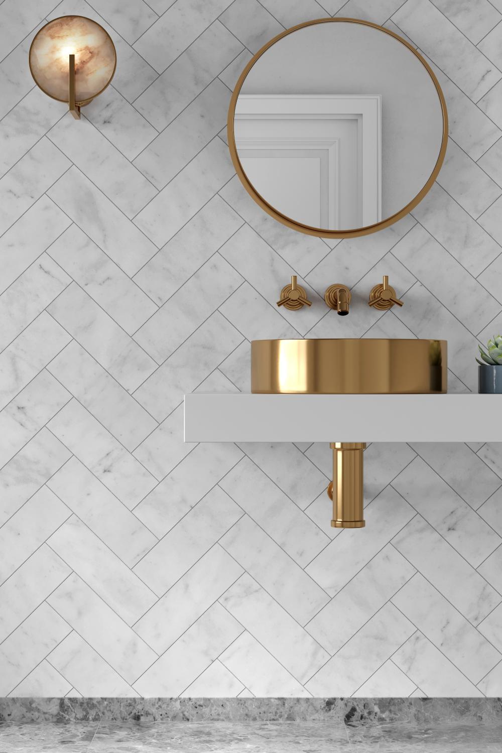Contemporary bathroom with floating shelf, gold-rimmed sink, and herringbone tile design