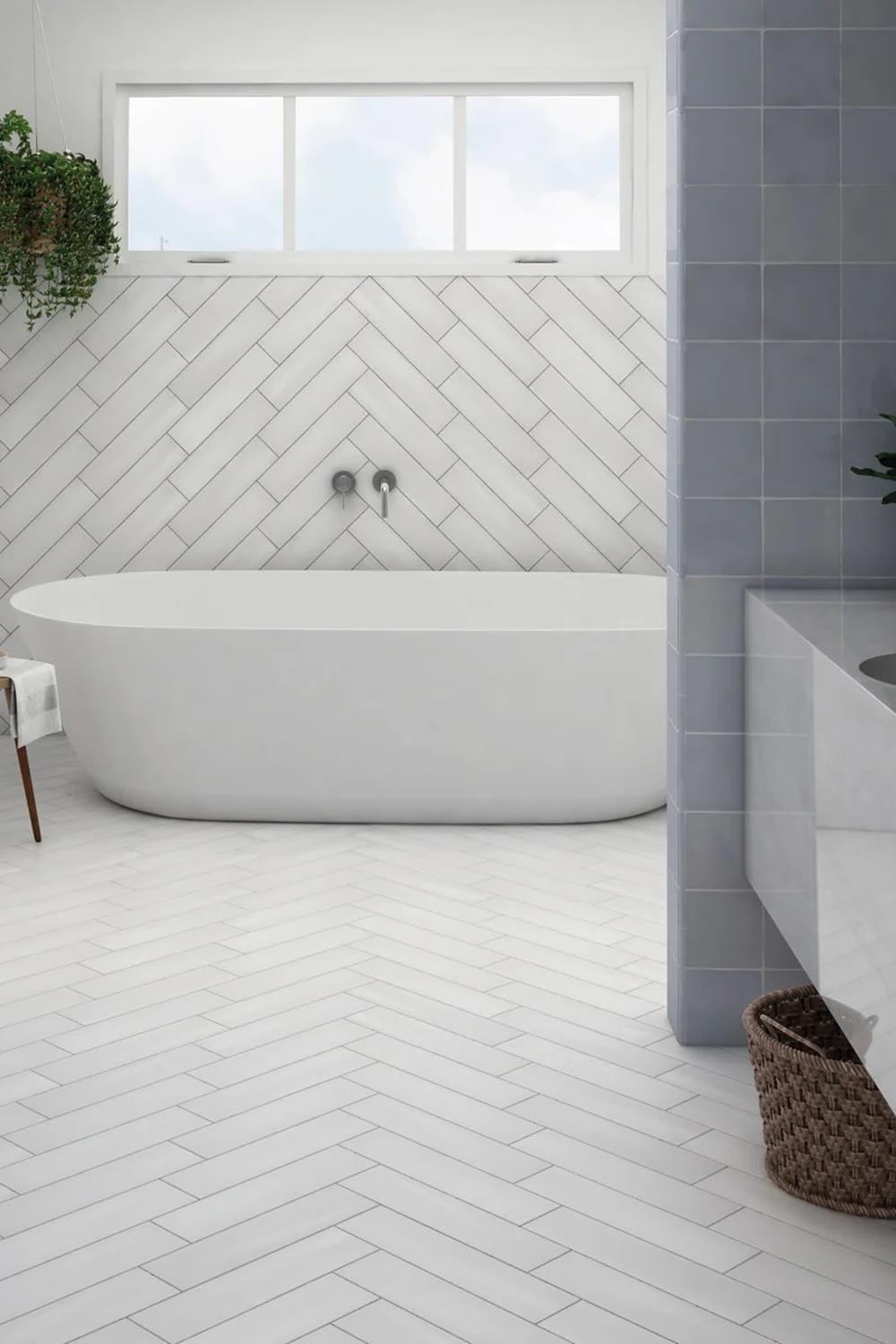 Contemporary bathroom featuring a freestanding bathtub and herringbone walls
