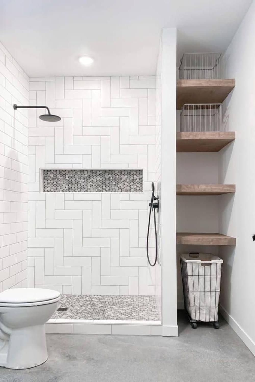 Stylish shower area with a herringbone wall and black fixtures