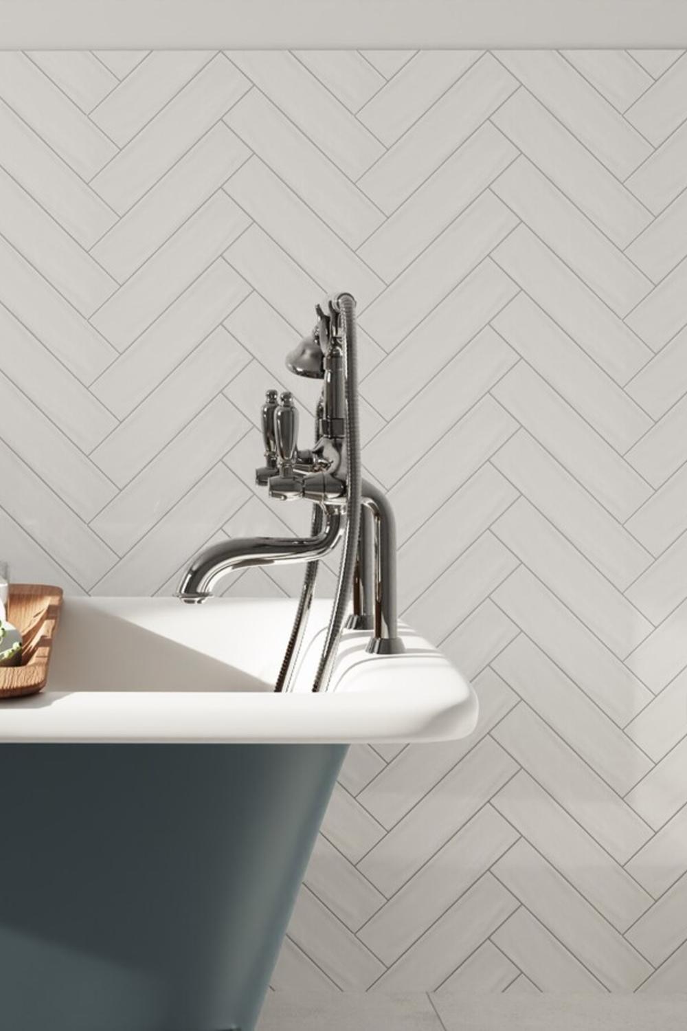 Stylish bathroom with a freestanding bathtub and beautiful herringbone tiles