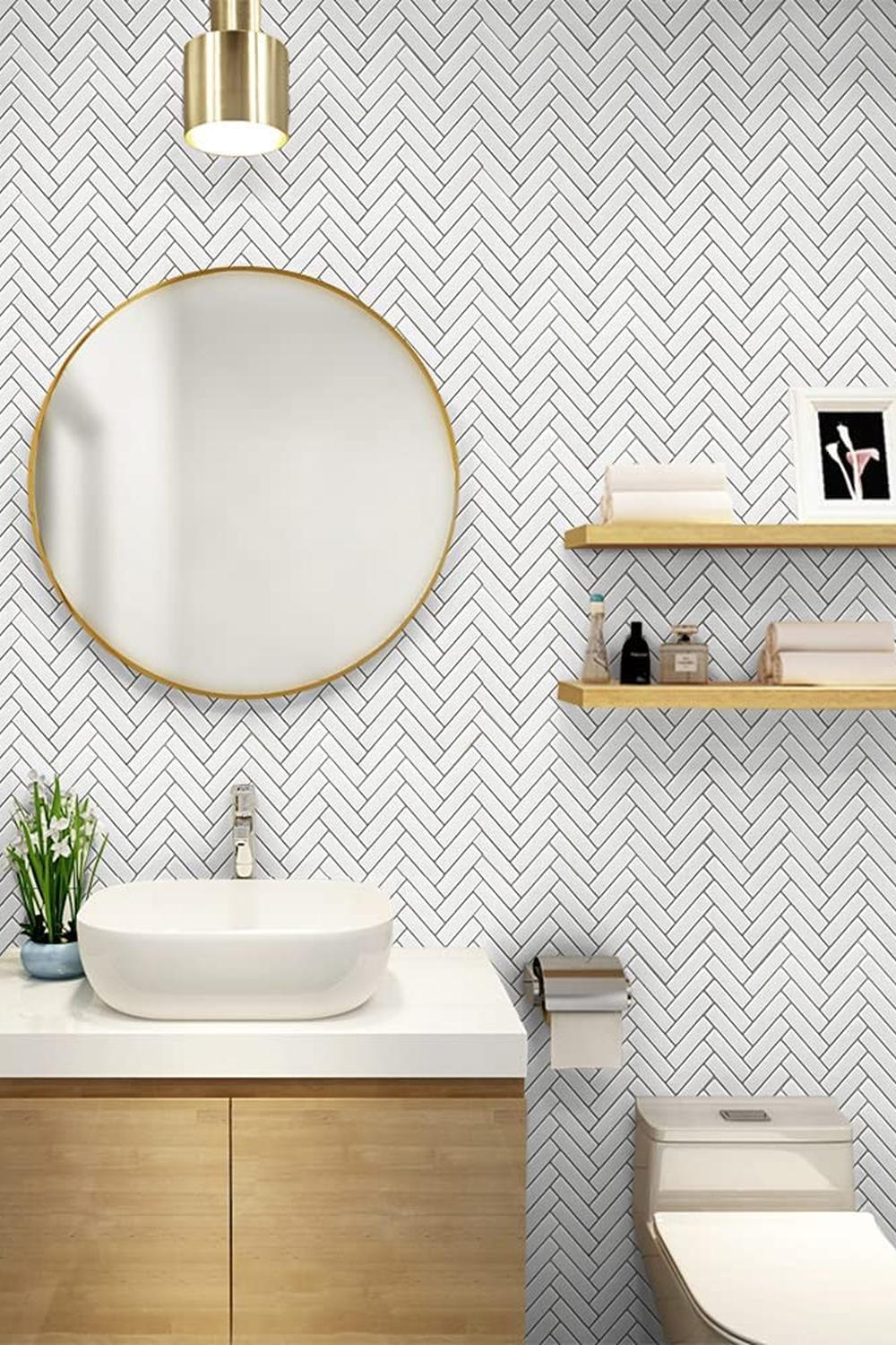 Stylish bathroom featuring round mirror and herringbone wall tiles