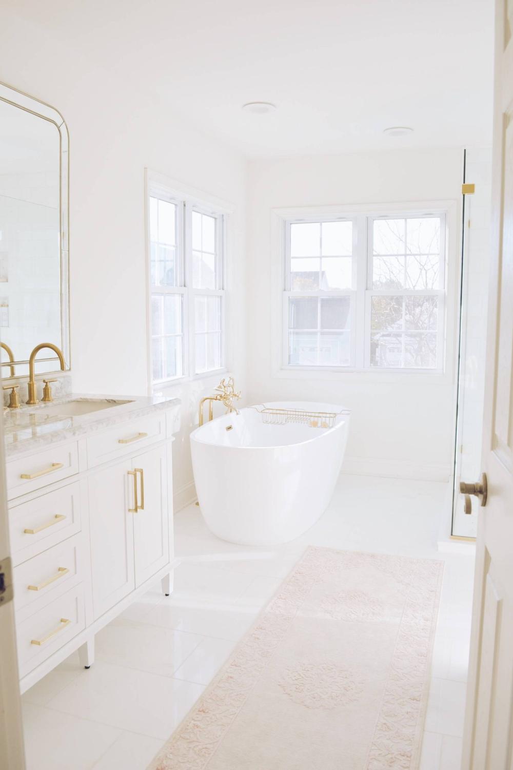 A stylish retreat featuring a freestanding tub and custom vanity.