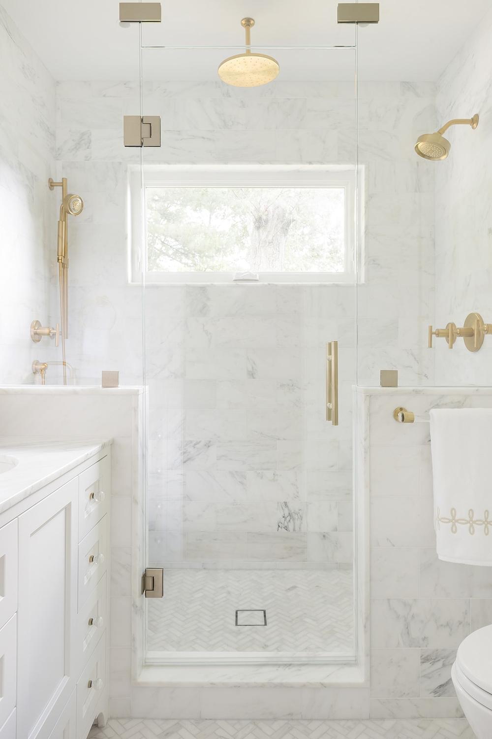 Elegant white marble bathroom showcasing clean lines and luxurious features.