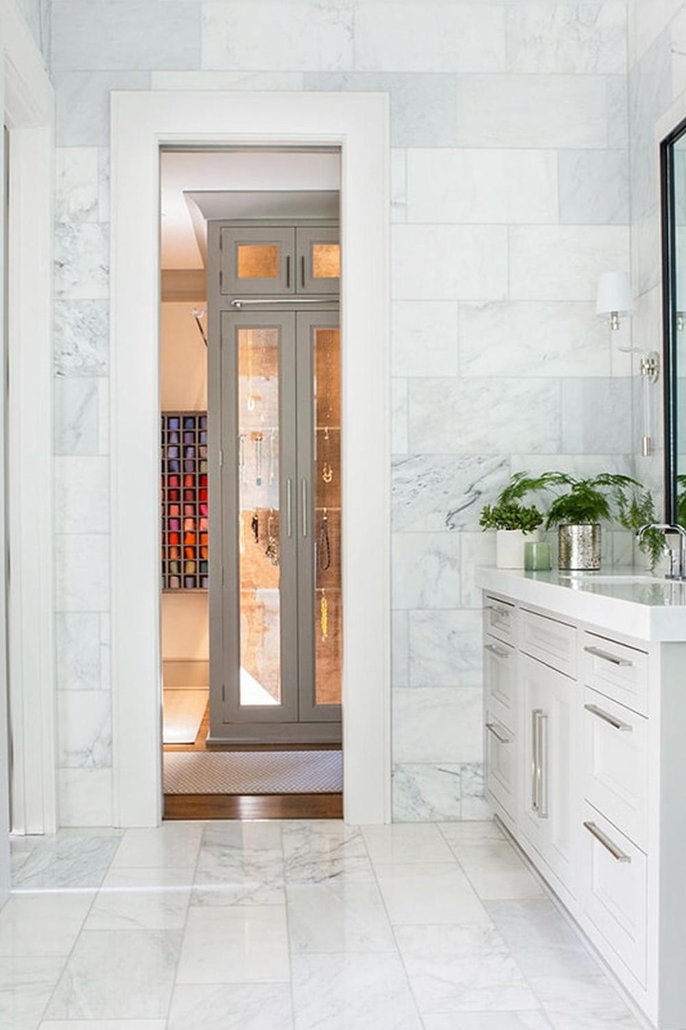 Luxury bathroom featuring large white marble tiles and dual cabinets for modern elegance.