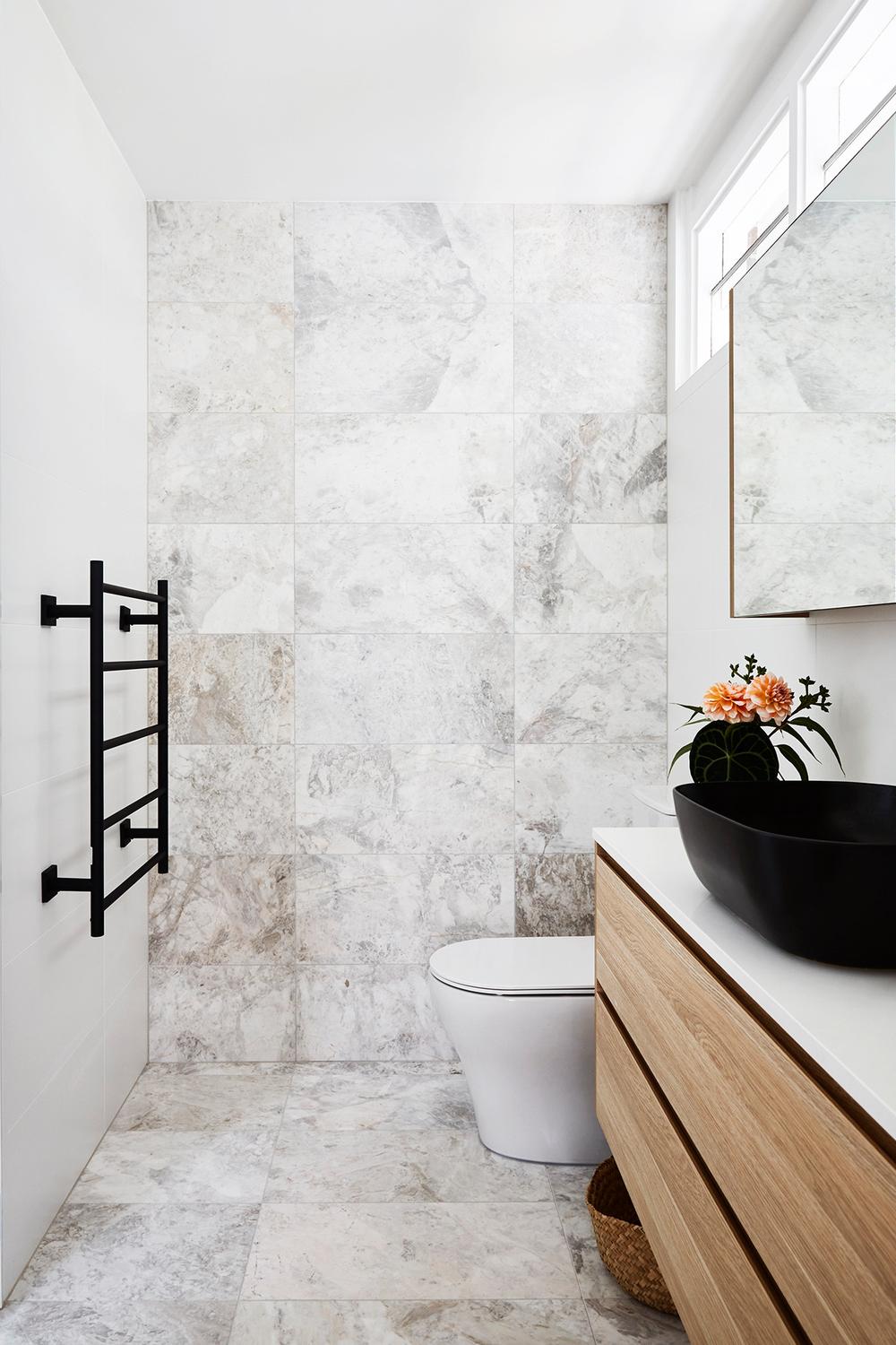 Modern bathroom featuring sleek design elements and white marble tiles for a sophisticated atmosphere.