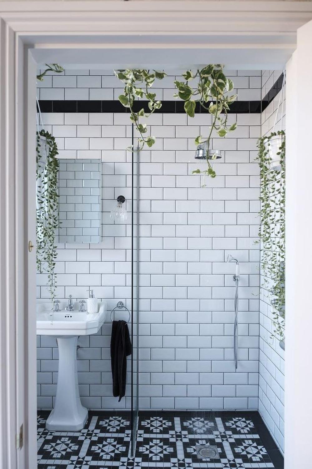 Modern bathroom with bold contrasting black and white patterned flooring