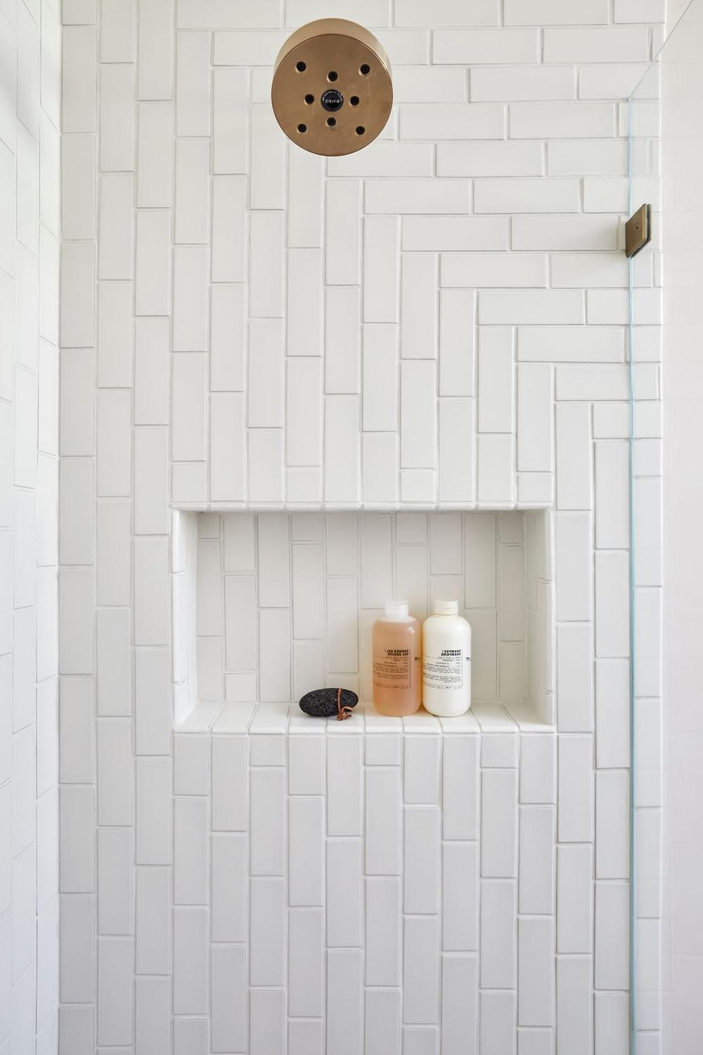 Bathroom featuring herringbone pattern tiles in a chic shower space
