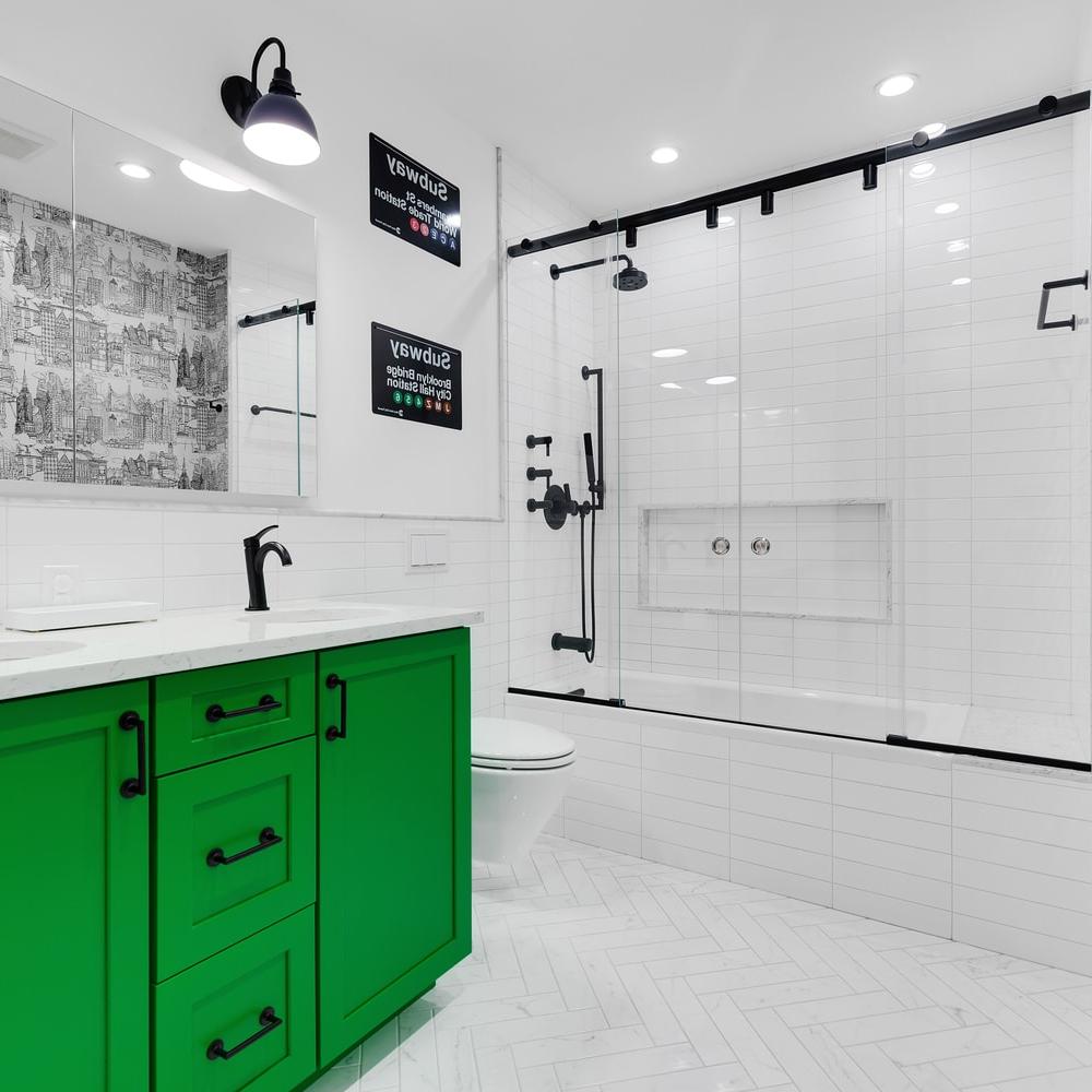 Vibrant bathroom design featuring a bright green vanity and clean white subway tiles.