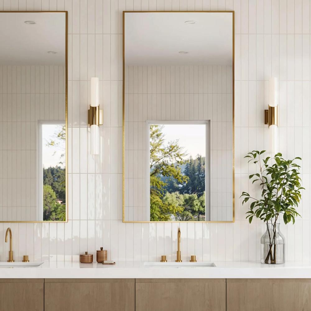 Contemporary bathroom design using white subway tiles, dual mirrors, and elegant fixtures.