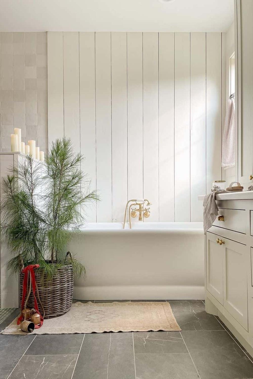 Serene bathroom with vertical shiplap walls, freestanding tub, and nature-inspired decor.