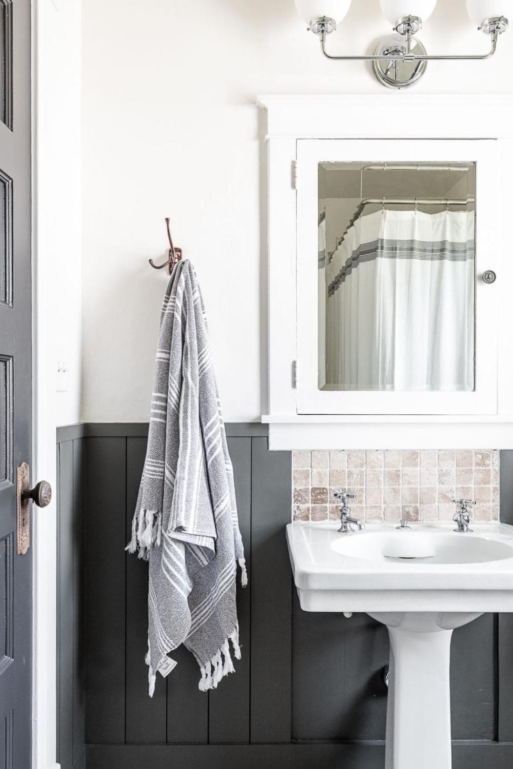 Stylish bathroom featuring a muted gray shiplap design paired with simple bathroom fixtures.