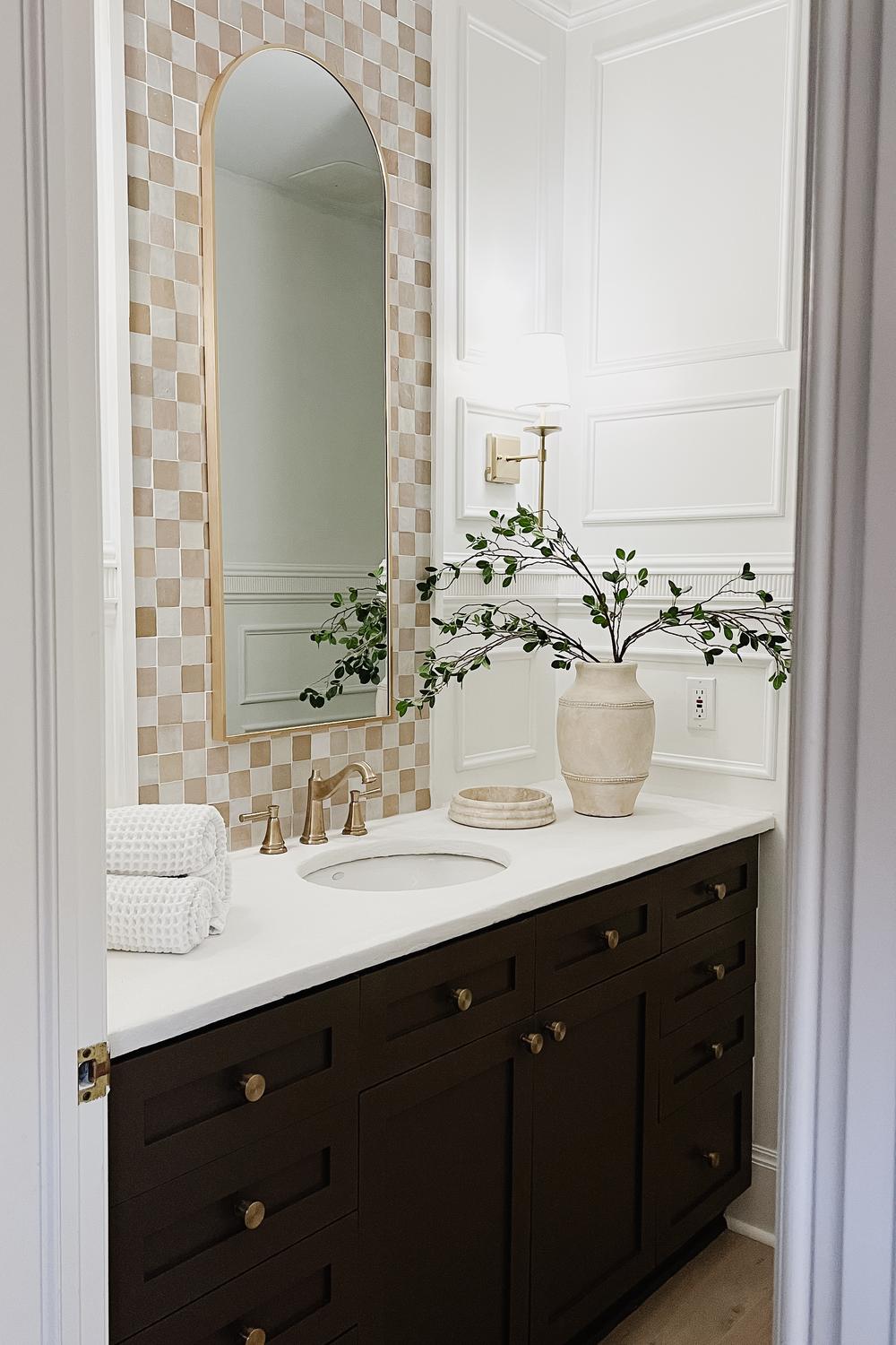 Stylish and modern bathroom featuring zellige tiles and decorative elements