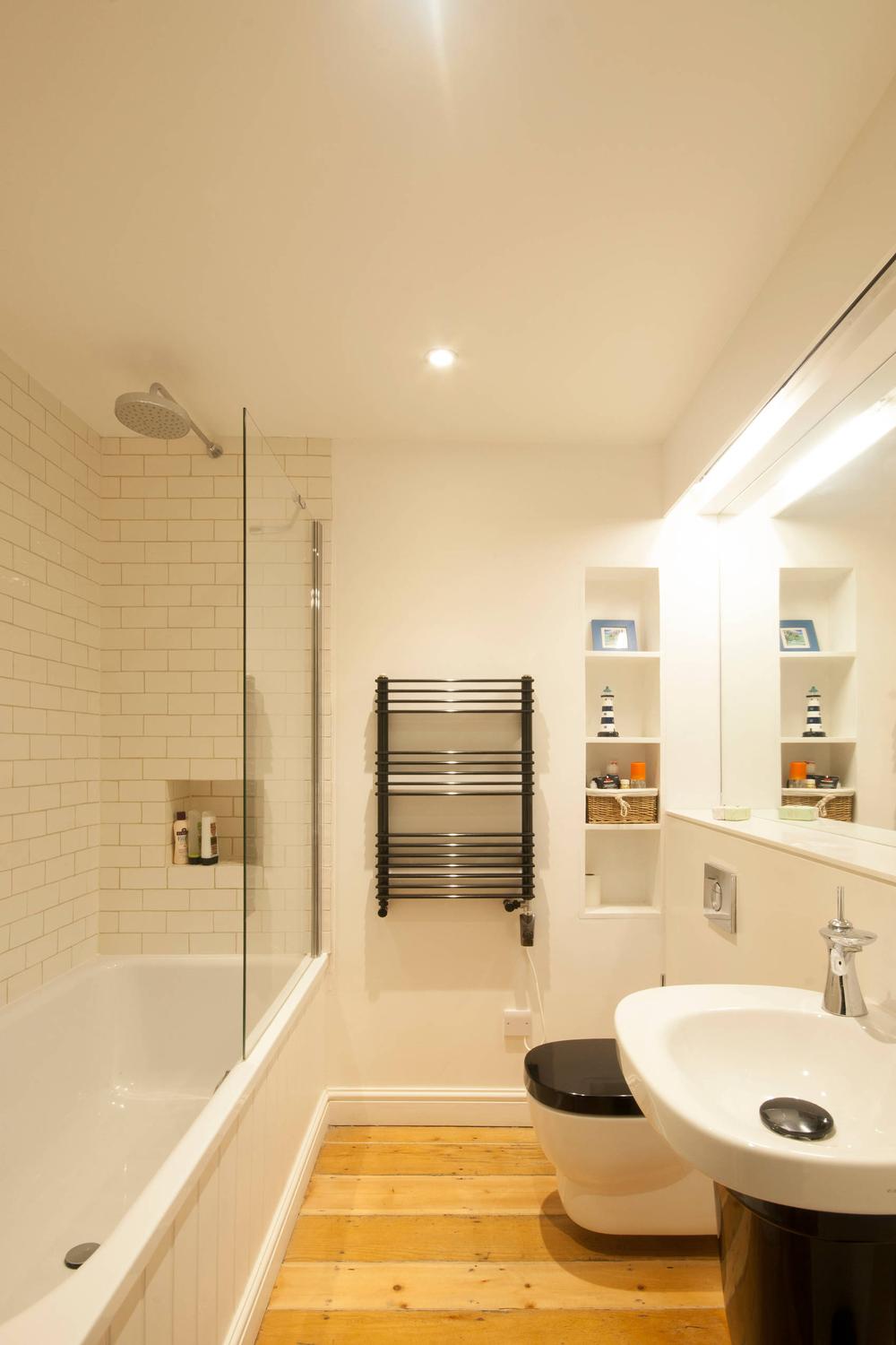 Stylish windowless bathroom with modern white fixtures