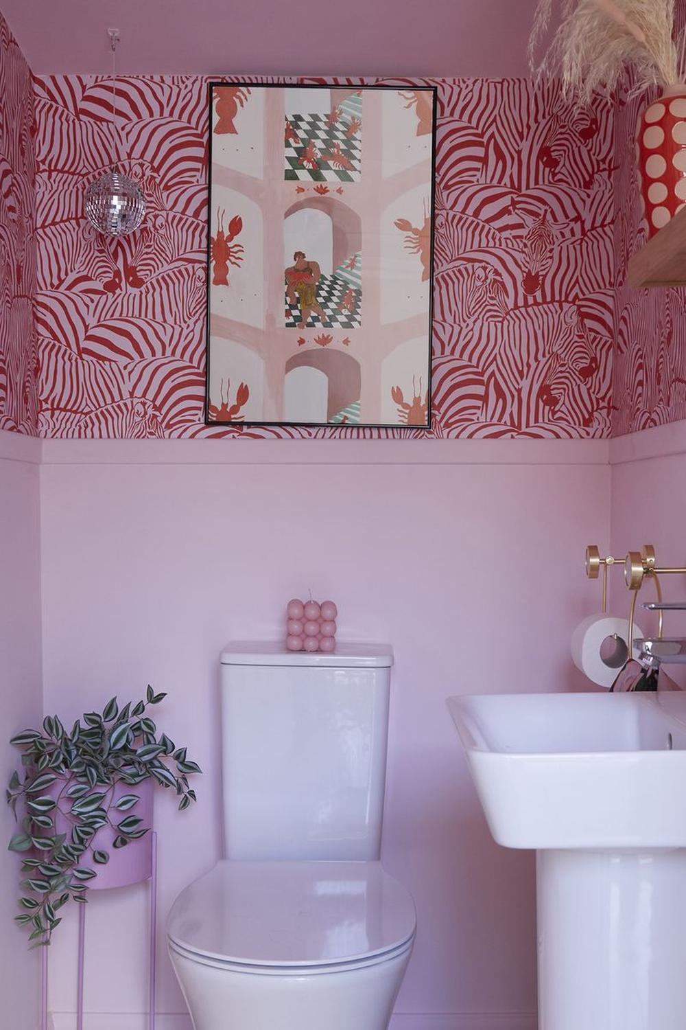 Colorful small bathroom featuring bold patterned wallpaper