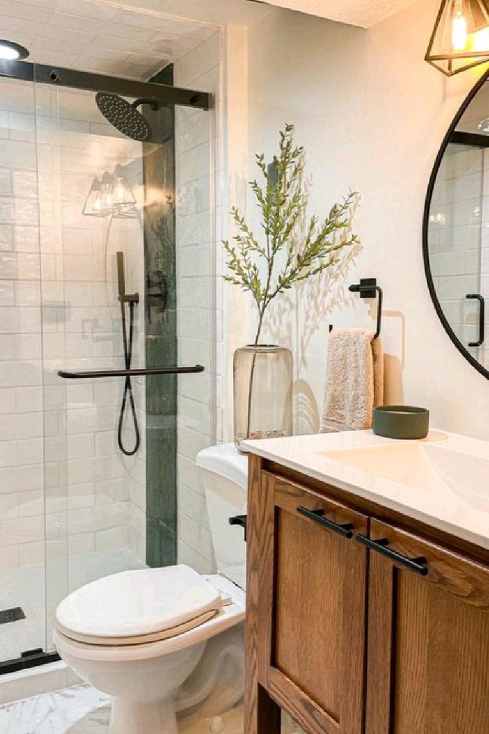 Small bathroom with modern glass shower enclosure and elegant vanity