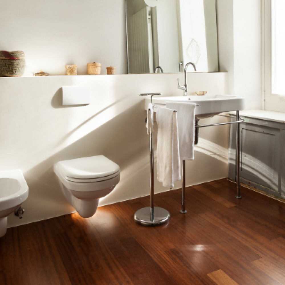 Stylish bathroom featuring dark wooden flooring, wall-mounted toilets, and minimalist design.