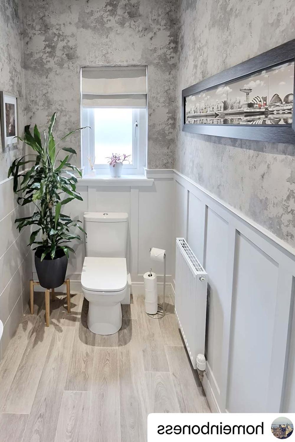 Baño contemporáneo con paneles de madera claros y decoración moderna