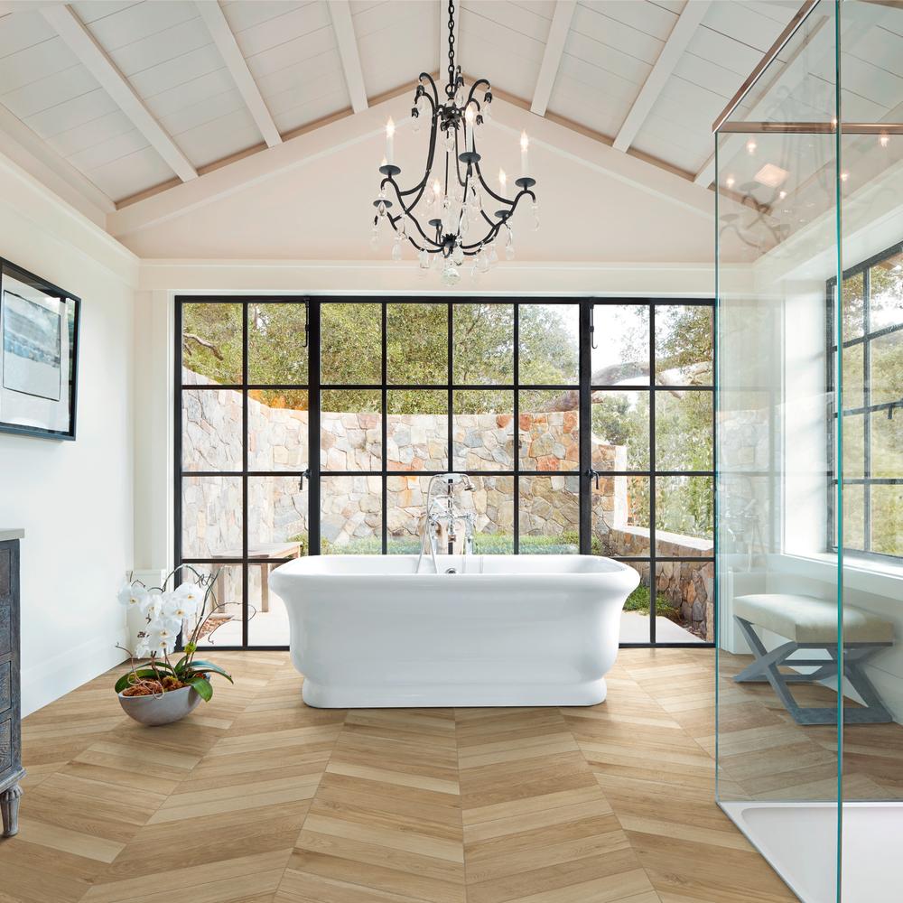 Luxurious bathroom with herringbone wood tile floor, natural light, and high-end fixtures.