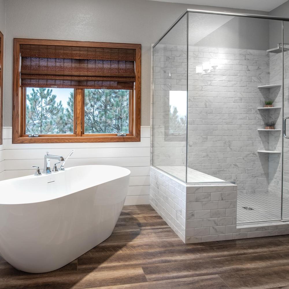 Graceful bathroom with dark wood-look tiles, modern amenities, and inviting decor.