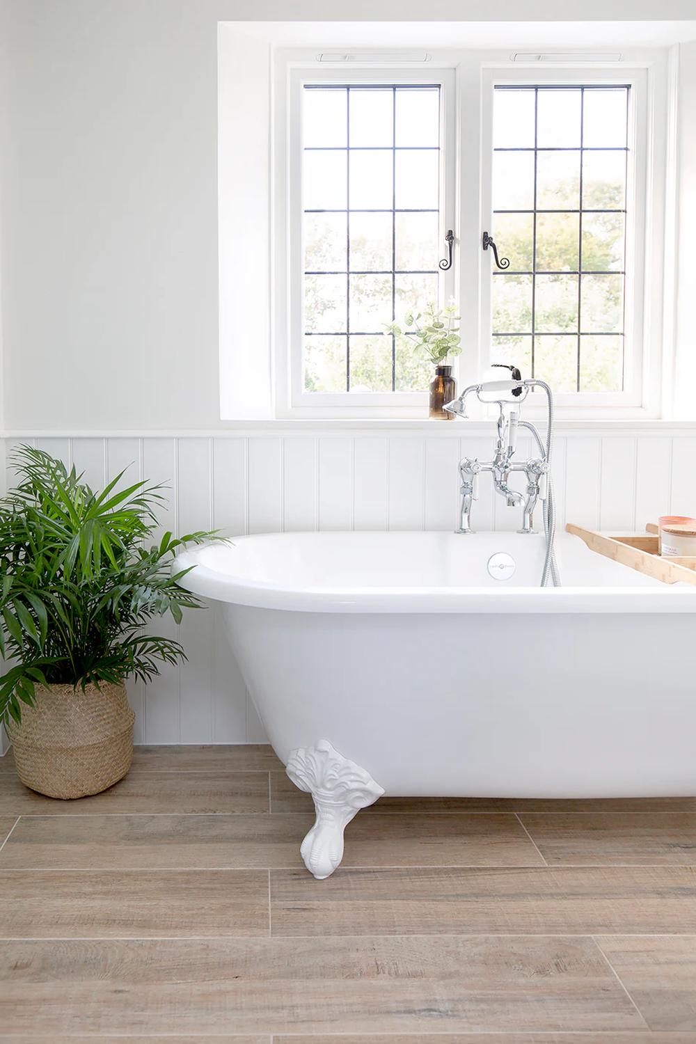 Charming bathroom featuring vintage-inspired elements and a warm wood tile floor.