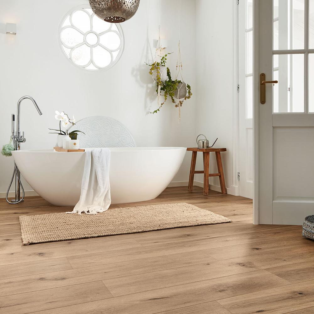 Sophisticated bathroom with light wood tile flooring, modern fixtures, and botanical decor.