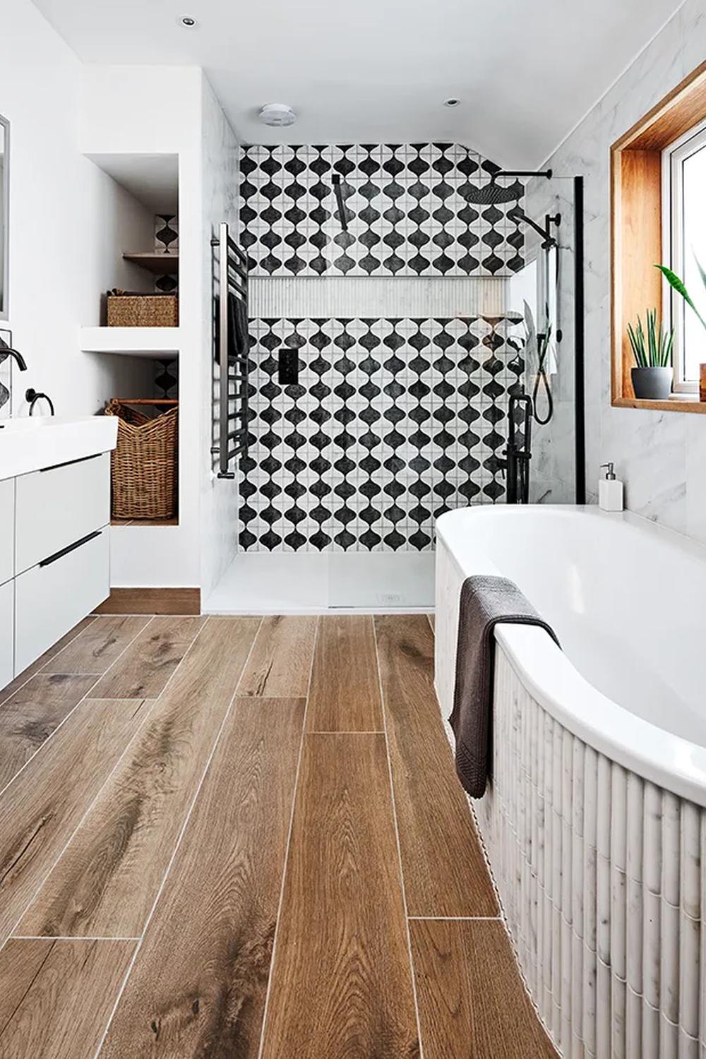 Stylish bathroom with bold geometric accents and a warm wood tile floor.