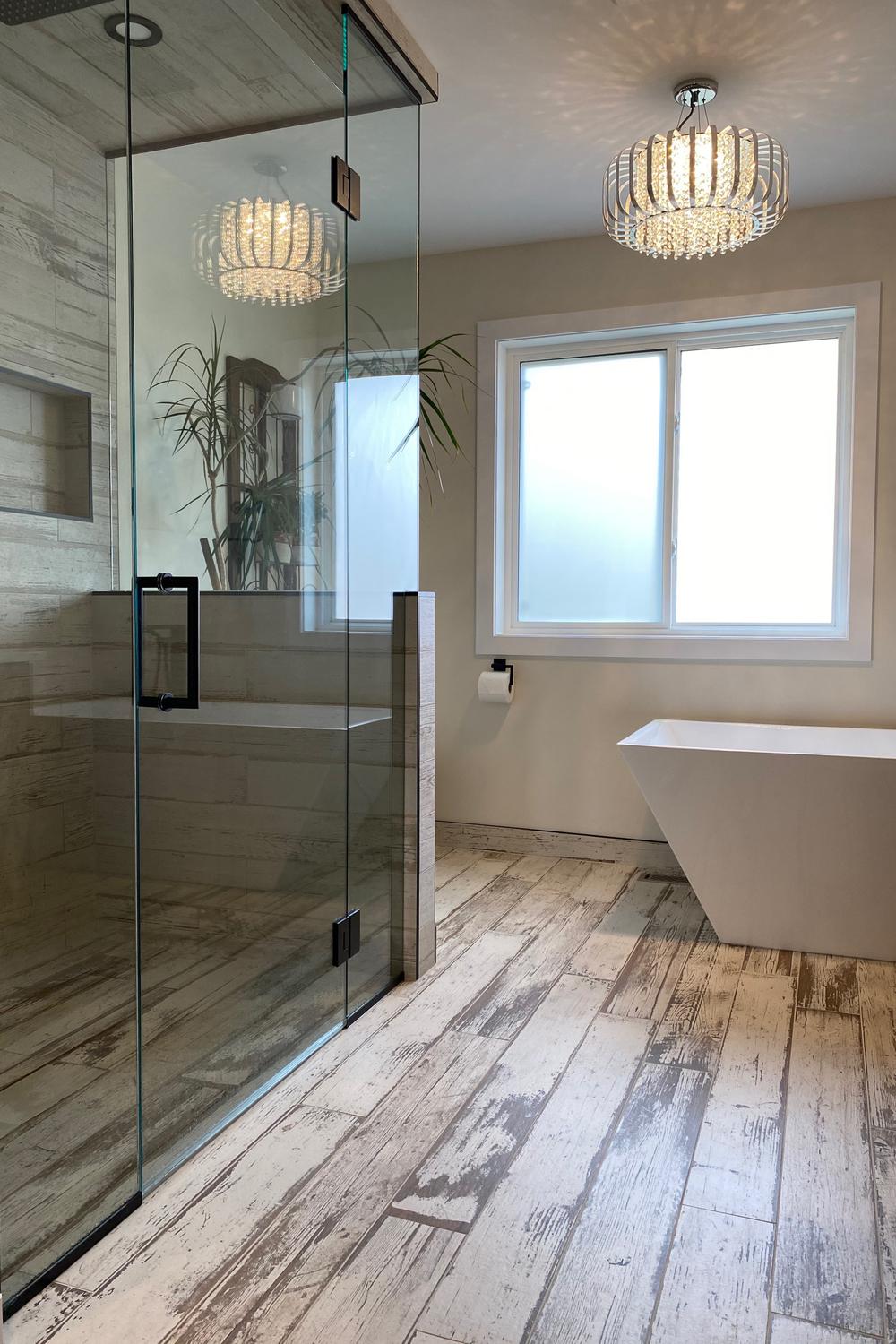 Contemporary bathroom design with a wood tile floor, sleek fixtures, and balanced color palette.