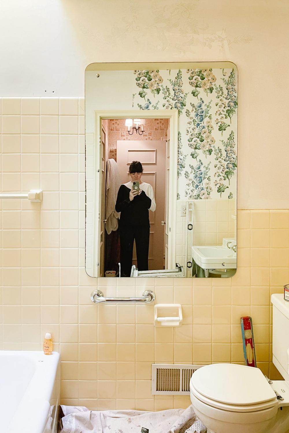 Vintage bathroom with pale yellow tiles and floral wallpaper