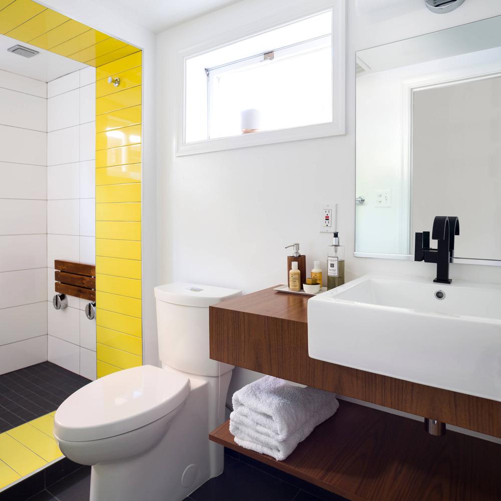 Modern bathroom design with vibrant yellow shower tiles