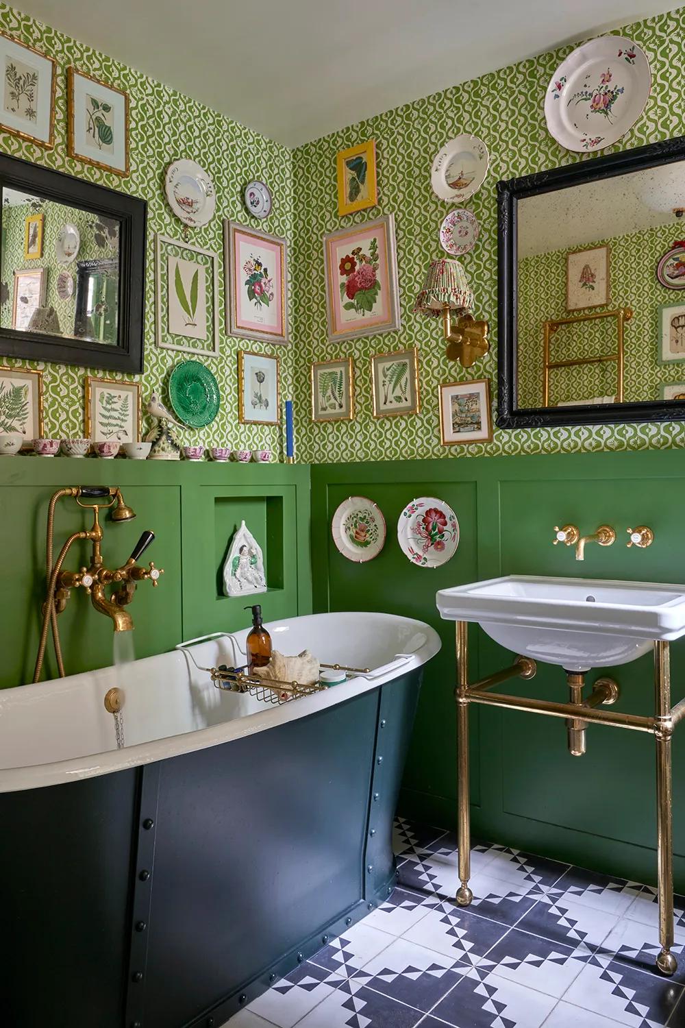 Eclectic bathroom with patterned wallpaper and vintage tub